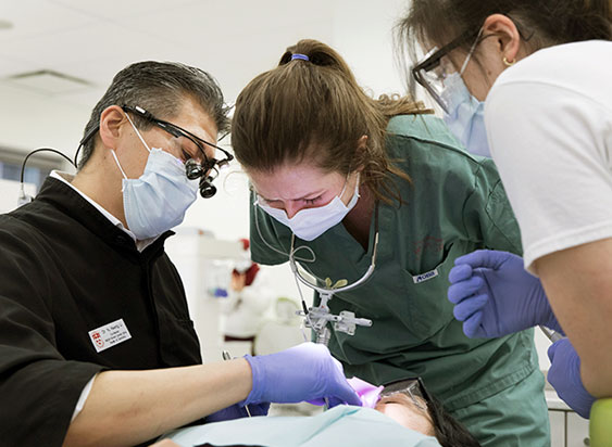 Dentist and technician performing an operation 