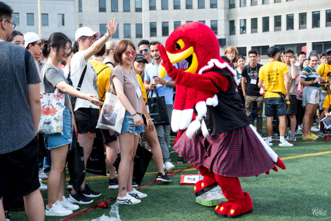 a group of students dancing with Marty, the 91社区 mascot
